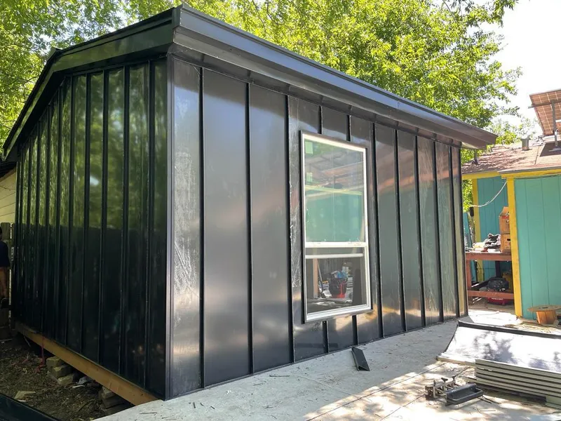 Black standing seam metal wall panels for Roof Inspection in Pauls Valley