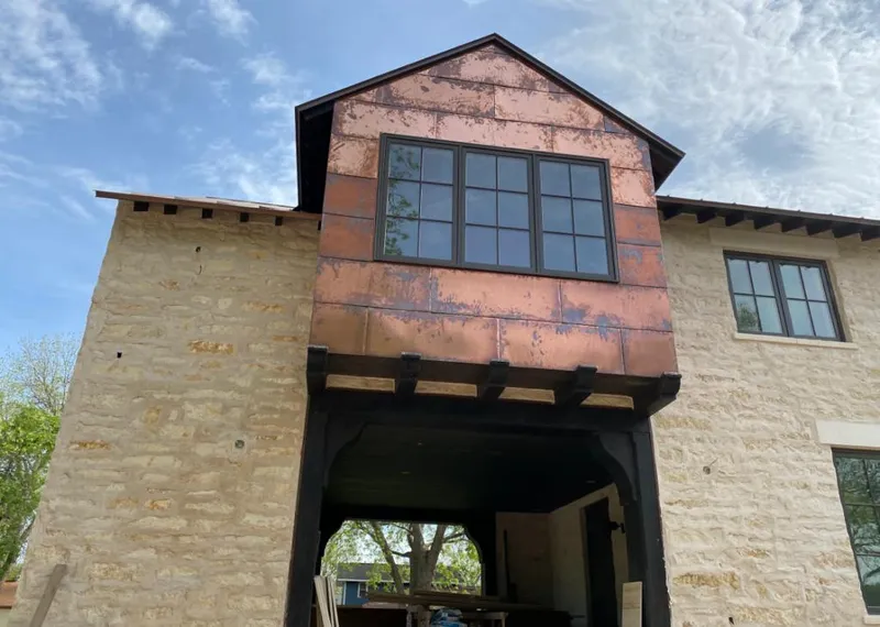 Copper metal panel facade on a stone building for Roof Repair in Pauls Valley